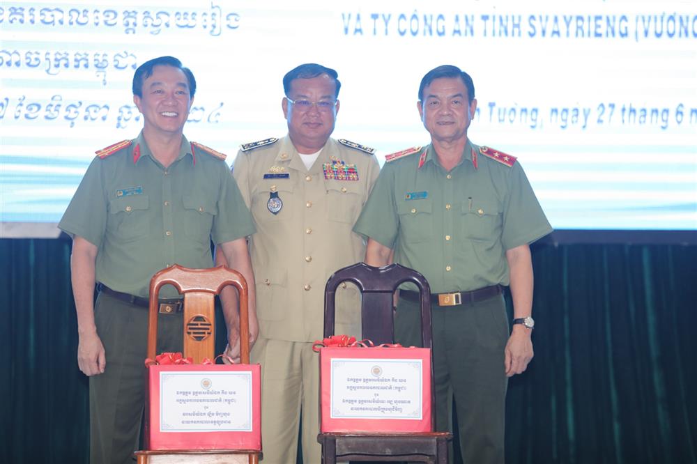 Đại tướng Kưng Khorn - Phó Tổng cục Công an quốc gia Campuchia trao tặng quà cho Trung tướng Lê Hồng Nam và Đại tá Lâm Minh Hồng