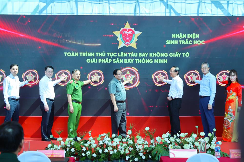 Thủ tướng Phạm Minh Chính và các đại biểu bấm nút triển khai giải pháp ứng dụng định danh, xác thực điện tử và nhận diện sinh trắc học phục vụ làm thủ tục lên tàu bay.