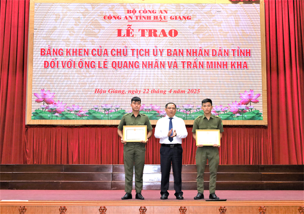 Đồng chí Trần Chí Hùng, Phó Chủ tịch UBND tỉnh Hậu Giang trao Bằng khen của Chủ tịch Ủy ban nhân dân tỉnh tặng 02 đồng chí bảo vệ an ninh trật tự ở cơ sở.