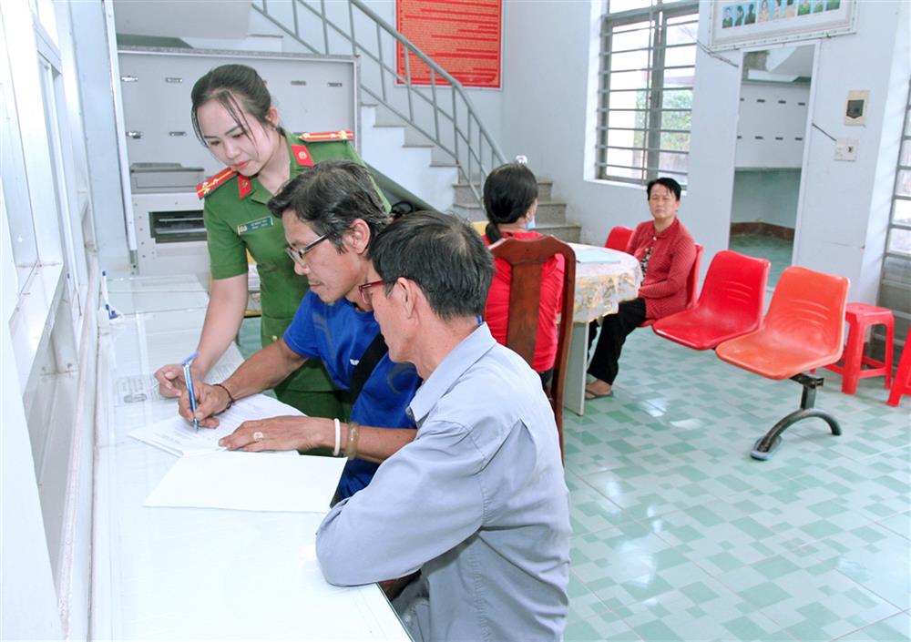 Thượng úy Lê Ngọc Thu hướng dẫn người dân thực hiện các thủ tục hành chính.